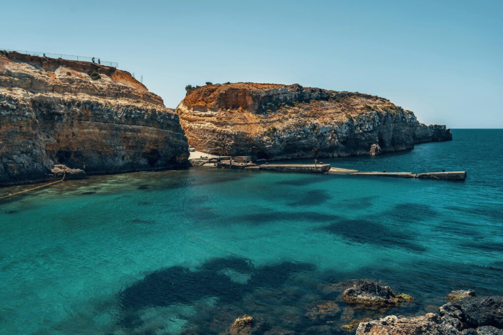 A captivating coastal scene of Gozo's cliffs with crystal-clear blue waters, perfect for travel inspiration.